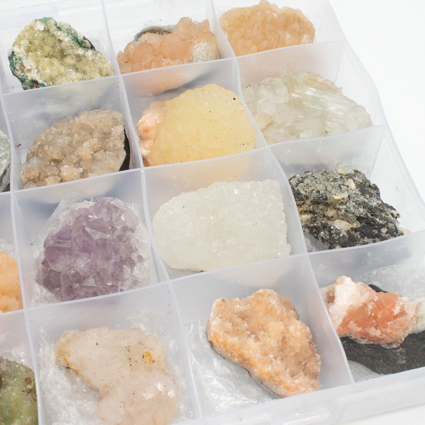 Mineral Specimens - Mixed Indian Zeolites in a Display (White Apophyllite, Stilbite,Finger Quartz, Amethyst, Green Stilbite, Heulandite) – lifestyle shot