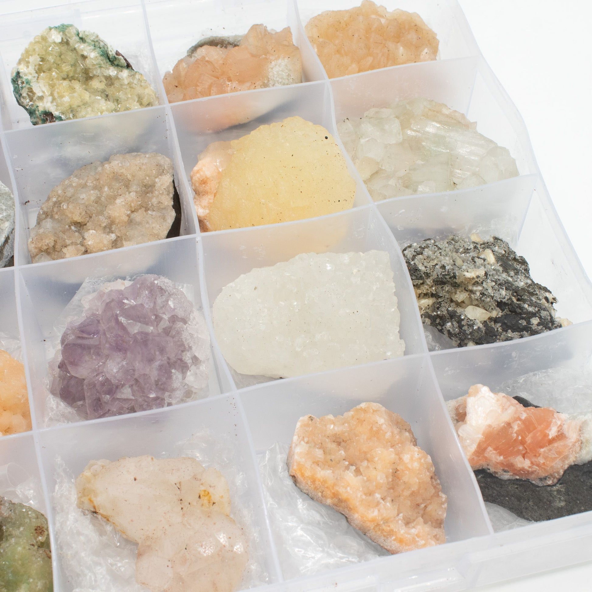Mineral Specimens - Mixed Indian Zeolites in a Display (White Apophyllite, Stilbite,Finger Quartz, Amethyst, Green Stilbite, Heulandite) – lifestyle shot